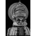 Realistic 16x23 inch charcoal and pencil drawing of a Kathakali dancer with intricate headgear titled Essence of Kathakali by The Indobrit Arts.