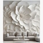 A large, 48x60-inch hand-carved plaster wall sculpture titled Ethereal Bloom A large, 48x60-inch hand-carved plaster wall sculpture titled Ethereal Bloom featuring a high-relief white floral design above a modern sofa.