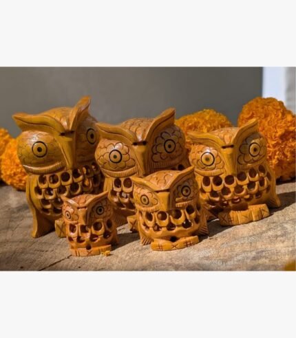 A set of five artisan-crafted wooden owl figurines eaturing detailed lattice carving and natural wood grain finishes.