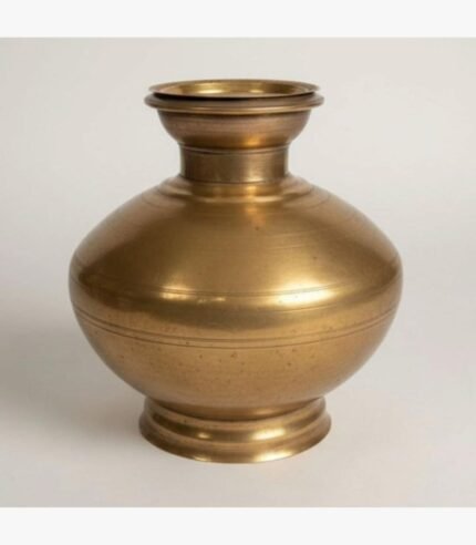 A premium handcrafted gold-finish brass ritual bell featuring a vertical feather-motif handle and a sacred Rudraksha bead, presented in a luxury red velvet box.