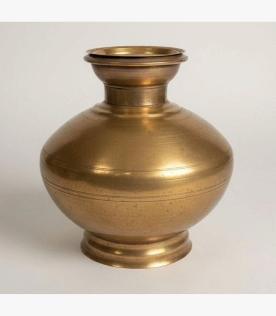 Sacred Feather and Rudraksha Brass Ritual Bell A premium handcrafted gold-finish brass ritual bell featuring a vertical feather-motif handle and a sacred Rudraksha bead, presented in a luxury red velvet box.