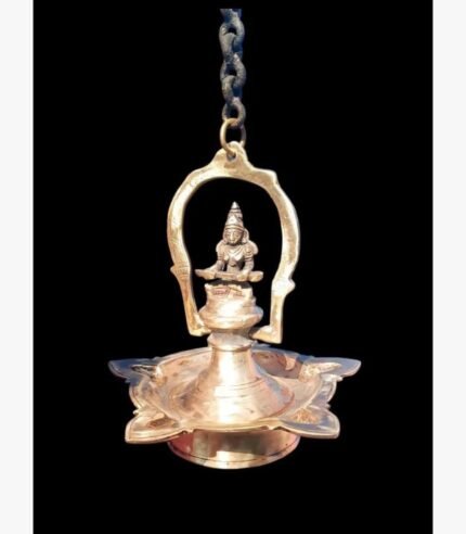 A handcrafted gold-finish brass pooja bell featuring an etched lotus petal handle and a sacred Rudraksha bead in a red velvet gift box.