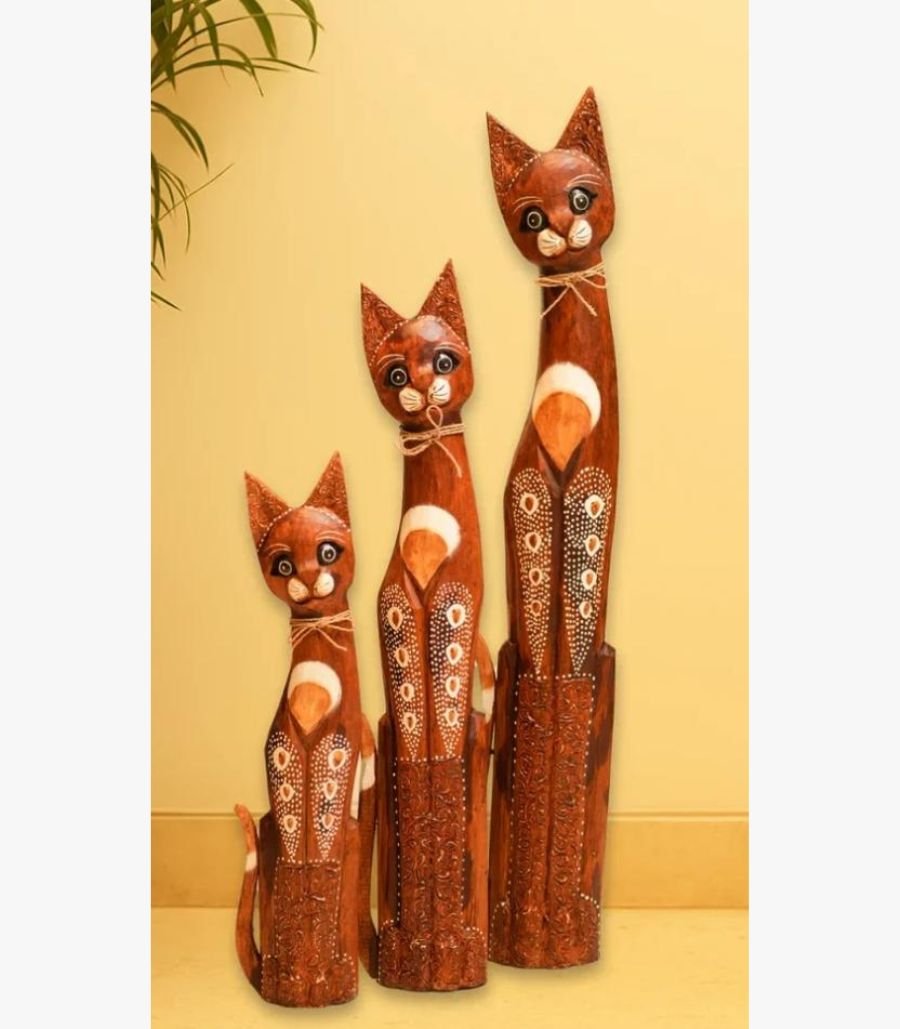 Stately Feline Trio Sculpture Set by Heritage Woodcraft Studios A set of three hand-carved mahogany wooden cat sculptures of varying heights, decorated with intricate dot-work patterns and jute accents.