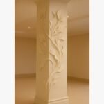 A custom-fitted, 8-foot tall architectural plaster sculpture of calla lilies wrapping around a structural column