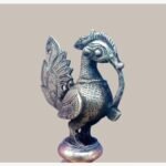 A handcrafted antique-finish Dhokra brass peacock sculpture featuring intricate tribal metalwork and traditional Indian lost-wax casting details.