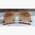 A set of two elegant gold-tone acrylic elephant figurines featuring intricate red detailing, standing on rectangular bases.