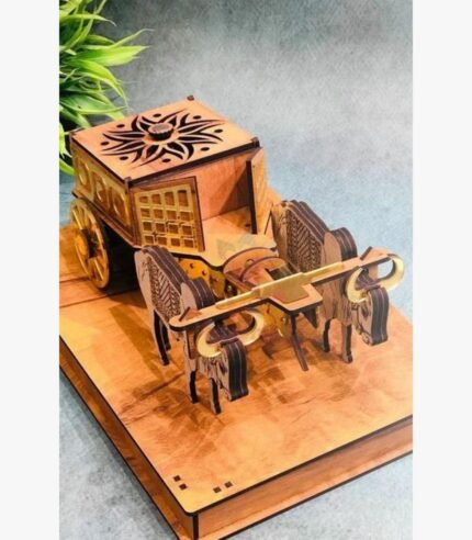 A perspective view of a handcrafted wooden bullock cart featuring intricate laser-cut sun motifs and golden metallic accents on a polished wooden base.