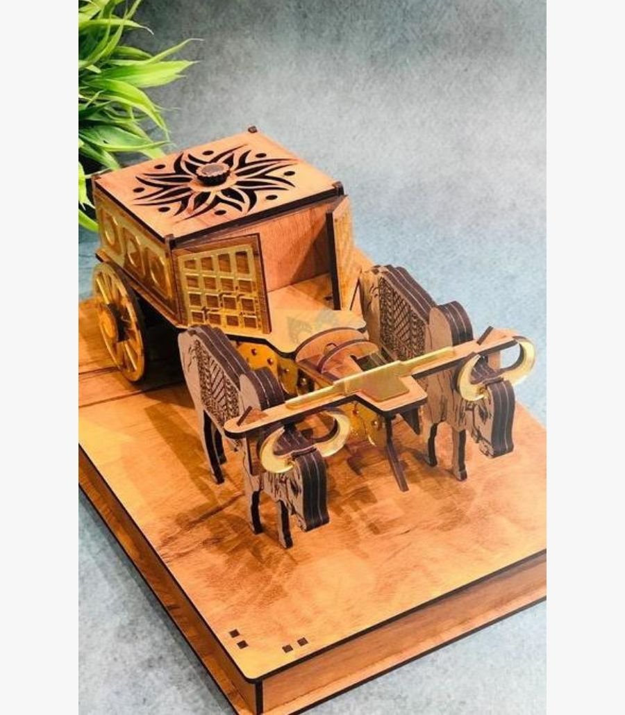 Handcrafted Wooden Bullock Cart with Gold Accents A perspective view of a handcrafted wooden bullock cart featuring intricate laser-cut sun motifs and golden metallic accents on a polished wooden base.