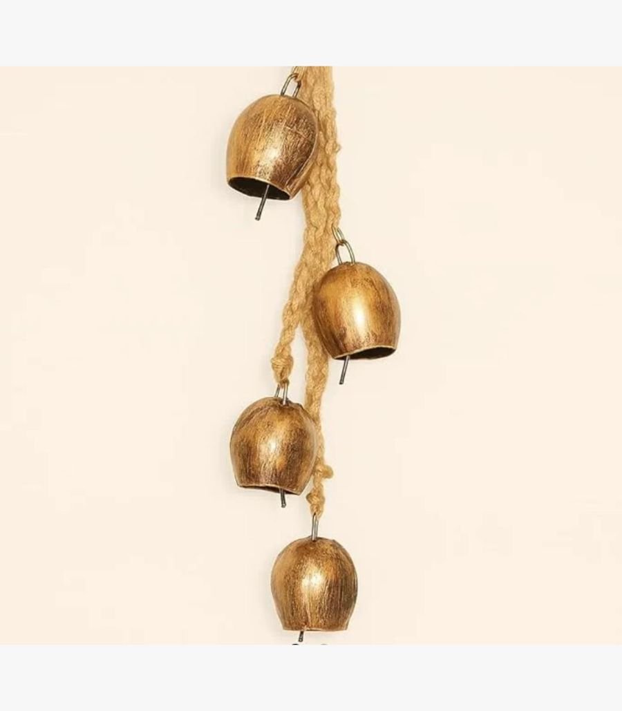 Golden Harmony Rustic Brass Bells Hanging Handcrafted rustic brass bells with a distressed golden finish suspended from a natural braided jute rope for spiritual home decor.