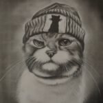 An original pencil sketch titled 'The Urban Feline' by Sunny Devani, depicting a cat wearing a knit beanie with a cat silhouette patch.