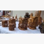 Hand-carved wooden owl sculpture showcasing intricate latticework and artisanal wood-carving detail.
