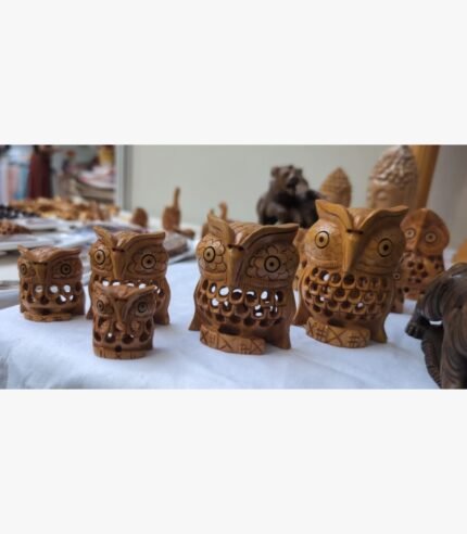 Hand-carved wooden owl sculpture showcasing intricate latticework and artisanal wood-carving detail.