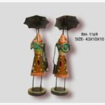 Handcrafted two-piece Rajasthani women with umbrellas iron sculpture set featuring hand-painted traditional green and red dresses on round pedestal bases.