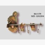 Handcrafted Lord Krishna flute and crown iron wall hook hanger featuring hand-painted traditional patterns and three storage hooks.