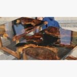 A matching set of two high-gloss live edge wooden tables featuring black epoxy resin rivers and intricate natural burl grains, handcrafted by Vina Bhavsar.