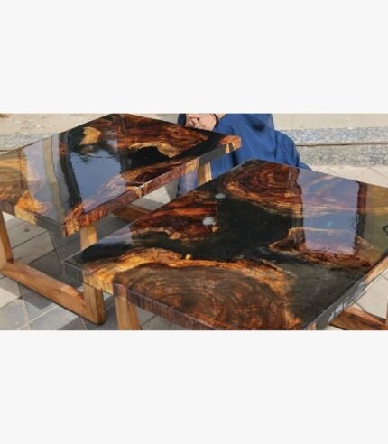 A matching set of two high-gloss live edge wooden tables featuring black epoxy resin rivers and intricate natural burl grains, handcrafted by Vina Bhavsar.