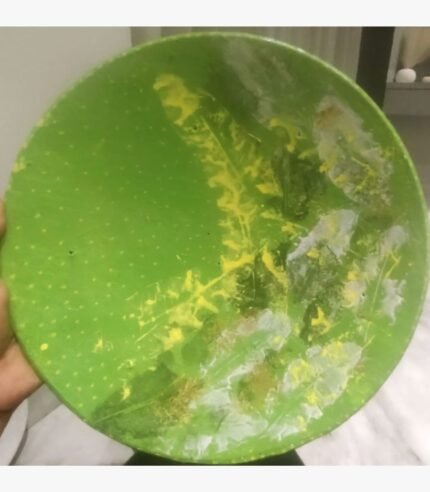Handcrafted circular decorative plate titled Verdant Canopy by Vina Bhavsar featuring a vivid lime green background with organic yellow and white leaf impressions and textured patterns.