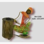 Handcrafted wrought iron traditional Indian tribal woman pen stand titled Tribal Grace by Crafts Heritage featuring vibrant red and green attire with detailed hand-painted patterns and a metallic mesh pen holder.