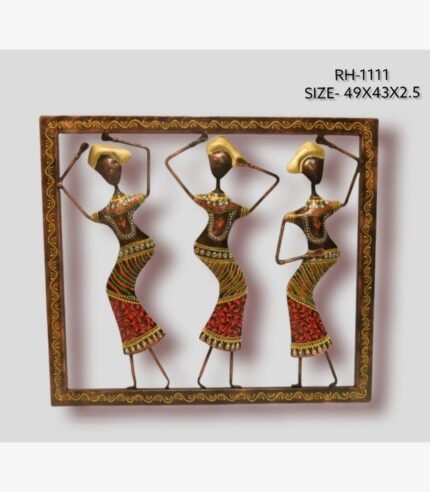 Handcrafted tribal women dancing metal wall art panel featuring three stylized figures with traditional headgear balanced inside a patterned square frame.