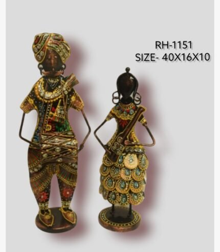 Handcrafted two-piece Rajasthani couple musicians iron statue set featuring a hand-painted traditional folk man playing a dholak and a woman with a stringed instrument on circular bases.