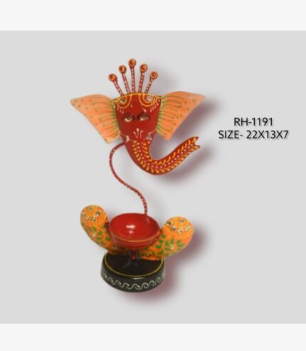Handcrafted wrought iron traditional Indian Lord Ganesha diya holder titled Sacred Silhouette by Crafts Heritage featuring a vibrant red face, orange fan-shaped ears, a five-pronged crown, and a central candle cup on a circular base.