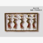 Handcrafted tribal women dancing metal wall art panel featuring five stylized female figures with traditional headgear in rhythmic postures within a patterned rectangular frame.