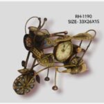 Handcrafted wrought iron vintage cruiser motorcycle sculpture desk clock titled Vintage Rider by Crafts Heritage featuring a textured bronze body adorned with vibrant traditional lacquer patterns and a built-in analog clock dial.