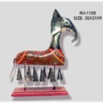 Handcrafted royal Rajasthani elephant metal sculpture table decor featuring a red painted body with green vine patterns and hanging metal bells on a stable pedestal base.