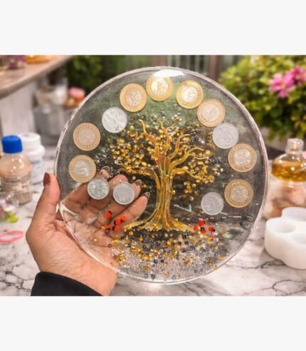 Handcrafted circular mixed media wall art panel titled Chakra Shrinidhi by Vina Bhavsar featuring a golden reflective tree of life accented with authentic Indian coins and shimmering crystal beads under clear resin.
