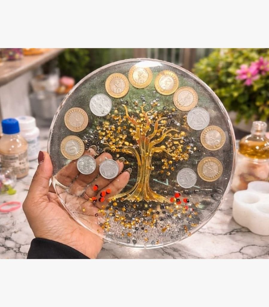 13 Handcrafted circular mixed media wall art panel titled Chakra Shrinidhi by Vina Bhavsar featuring a golden reflective tree of life accented with authentic Indian coins and shimmering crystal beads under clear resin.