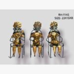 Handcrafted three-piece Rajasthani musicians sitting on rocking chairs iron statue set featuring hand-painted gold attire and traditional folk instruments.