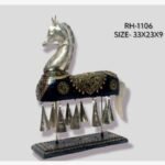 Handcrafted royal Rajasthani horse metal sculpture table decor featuring a dark black painted body with intricate gold patterns, studded gems, and hanging metal bells on a sturdy pedestal.