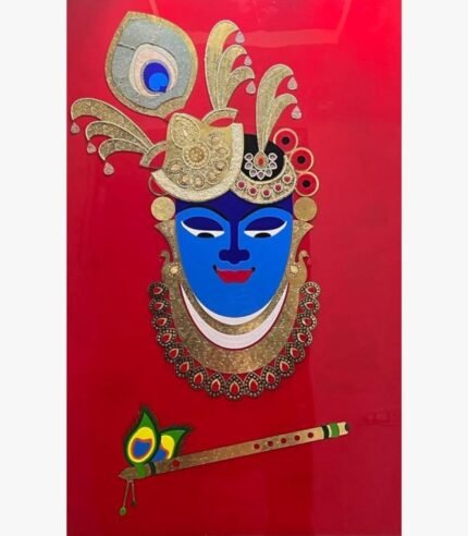 Handcrafted traditional Shrinathji mixed media relief wall art titled Divine Shrinathji featuring a blue face icon with an ornate gold mukut, peacock feather, and holy bansuri flute on a solid red background panel.