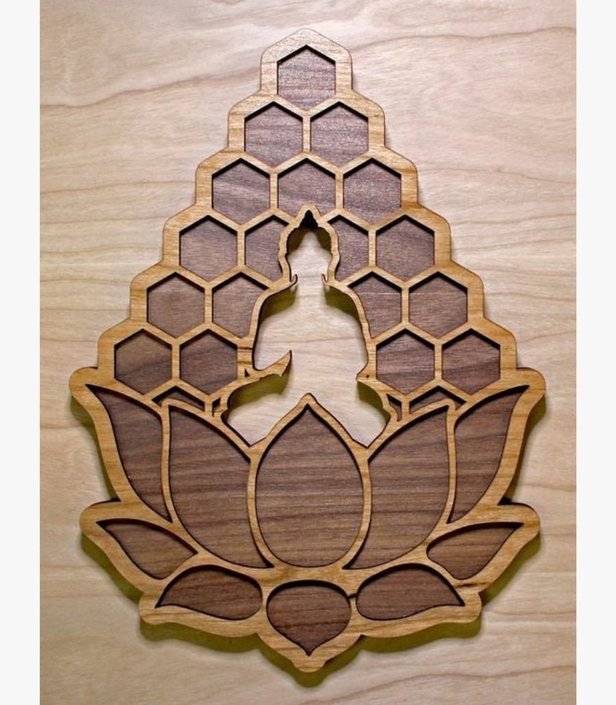 15 Handcrafted 3D layered wooden wall art titled Honeycomb Buddha Serenity showing a central silhouette cut-out of a meditating Buddha emerging from a lotus blossom base below a geometric honeycomb lattice backdrop.