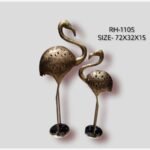 Handcrafted pair of golden flamingo metal sculptures featuring intricate cut-out lattice work on the bodies and slender legs mounted on circular bases.