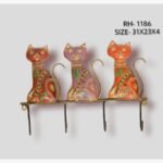 Handcrafted wrought iron decorative wall hanger with 4 hooks titled Feline Fable by Crafts Heritage featuring three vibrant red, purple, and orange hand-painted cats sitting in a row with curled wire tails.
