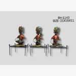 Handcrafted three-piece Rajasthani musicians sitting on traditional cots iron statue set featuring hand-painted red and orange attire playing folk instruments.