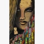 An abstract figurative portrait acrylic painting on canvas of a woman with striking eyes, gold leaf accents on her forehead, and colorful geometric city-like patterns in the foreground.