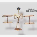 Handcrafted tribal man carrying baskets metal sculpture with a stick figure design balancing two rectangular frames on a circular pedestal base.