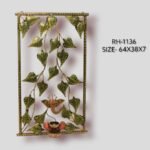 Handcrafted Ganesha Bodhi leaf metal wall art panel featuring cascading green peepal leaves and a central Lord Ganesha motif with an integrated diya holder inside a rectangular frame.