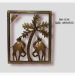 Handcrafted desert camels and palm tree metal wall art panel featuring two traditional painted iron camels under a golden sun and palm fronds in a rectangular frame.