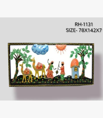Handcrafted Rajasthani village life metal wall art panel depicting a colorful scene with dancing folk figures, a camel caravan, lush trees, and a small hut inside an embossed black frame.