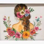 Original watercolor and pencil illustration titled Floral Harmony by Sachi Patel showing the back view of a woman with braided brown hair adorned with vibrant pink, white, and orange flowers.