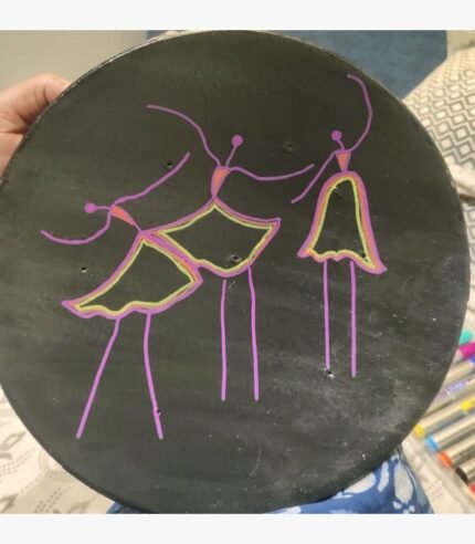 Handcrafted circular decorative plate titled Midnight Dancers by Vina Bhavsar featuring three minimalist stylized stick-figure ballerinas sketched in neon purple, pink, and lime green lines on a solid matte black background.