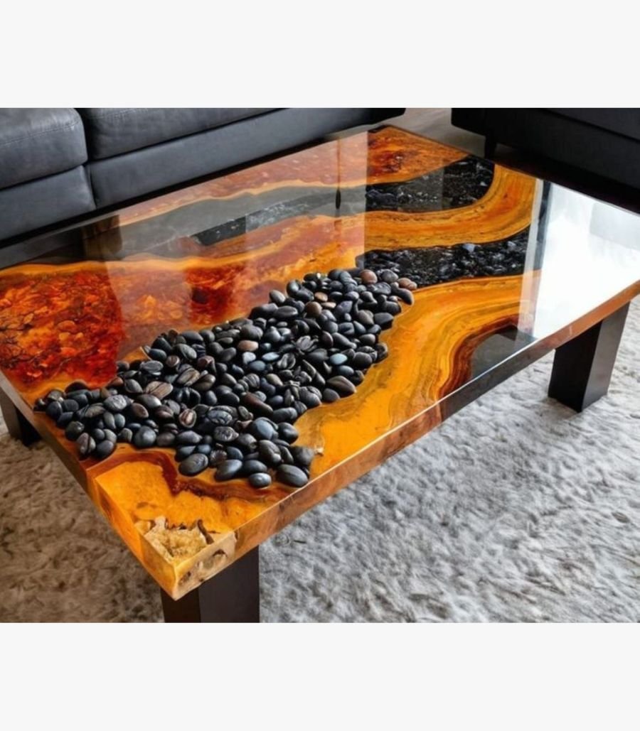 6 Luxury live edge burl wood coffee table titled Lava Flow by Vina Bhavsar featuring a black epoxy resin river channel filled with smooth black river stones under a high-gloss finish.
