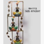 Handcrafted vertical tiered Rajasthani musicians metal wall art panel featuring three figures with traditional turbans in rectangular frames decorated with metallic leaves.
