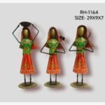 Handcrafted three-piece Rajasthani women performing daily chores iron sculpture set featuring hand-painted red ghagras and green cholis on round pedestal bases.