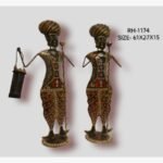 Handcrafted two-piece Rajasthani village guards iron sculpture set featuring hand-painted red patterned dhotis, multi-colored turbans, a staff, and a lantern.