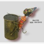 Handcrafted wrought iron traditional Indian monkey pen stand titled Playful Monkey by Crafts Heritage featuring a black painted head with a blue conical hat and red patterned body climbing a brass-gold metallic perforated storage cylinder.