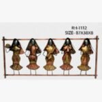 Handcrafted metal wall art frame featuring five traditional Indian women musicians with veils playing folk instruments within an iron panel.